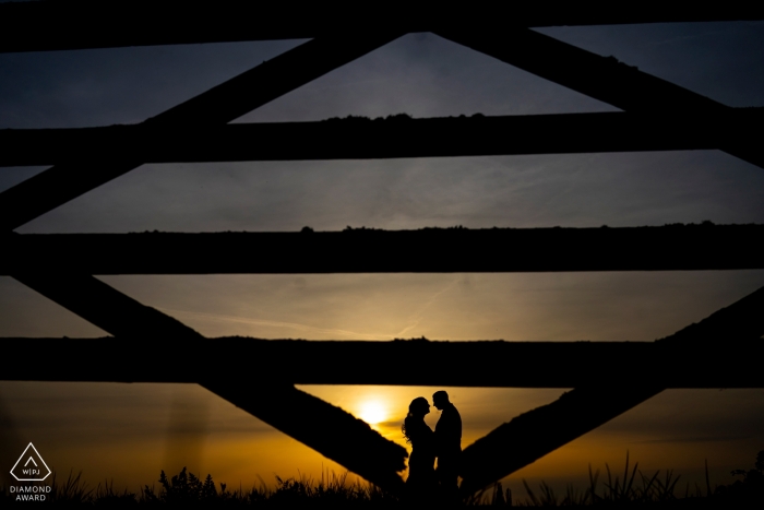 Photo by: <a href="https://www.wpja.com/photos/diamond-award-top-wedding-engagement-photographer/2444706">David Pullum - Exeter Devon Rockbeare Manor Sunset engagement shoot - portrait with A gate and a couple