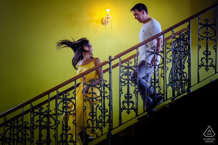 Casarão Serra do Ouro Pré-wedding portrait photo shoot with a couple coming down on the indoor stairs