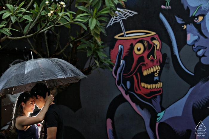 Diablo Pub Pré-mariage séance de portrait de couple avec une lumière, un parapluie et des peintures murales de graffitis sur le mur