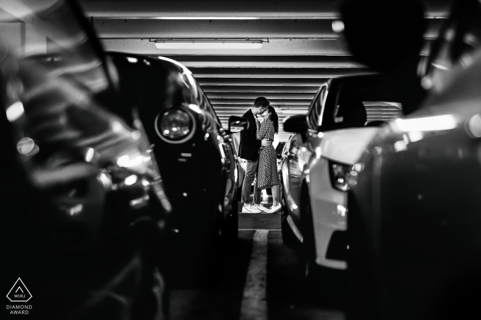 Agen, France Engagement portrait between parked automobiles