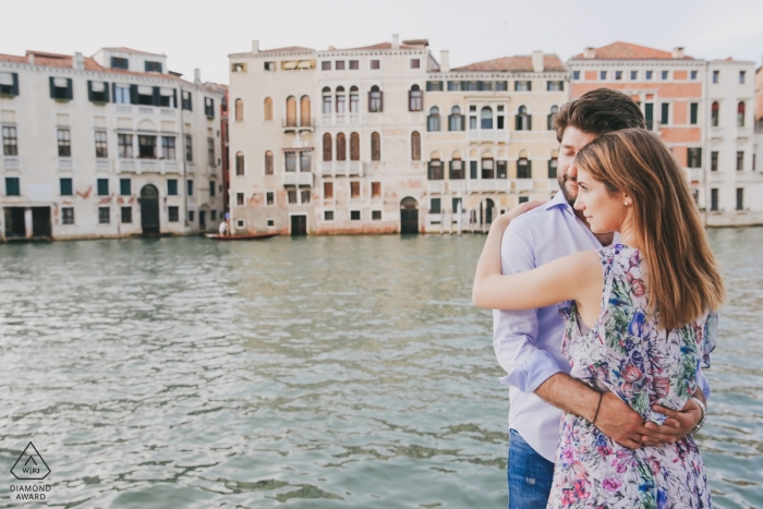 Photo by: <a href="https://www.wpja.com/photos/diamond-award-top-wedding-engagement-photographer/2432781">Marta Buso - Venezia Venezia engagement portrait in Venice, Italy | an engaged couple embraces at the water