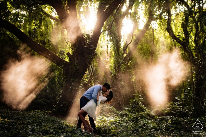 Kapalua, Hawaii Engagement Photography - Couple in the jungle with sun rays coming through the trees