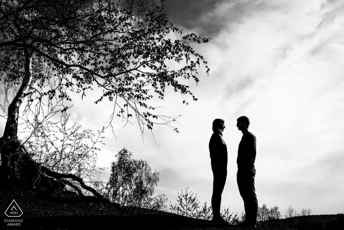 Photo by: <a href="https://www.wpja.com/photos/diamond-award-top-wedding-engagement-photographer/2455946">Rosa Engel - Aachen Nordrhein-Westfalen Black and white engagement photo of a couple silhouetted outside in Aachen.