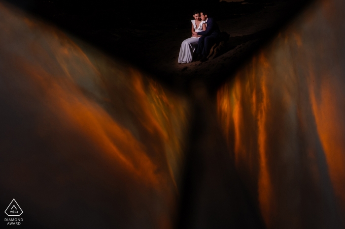 Photo by: <a href="https://www.wpja.com/photos/diamond-award-top-wedding-engagement-photographer/2456261">Raymond Nguyen - Sacramento California Engagement photo of a woman sitting on a man's lap in the distance in San Francisco.