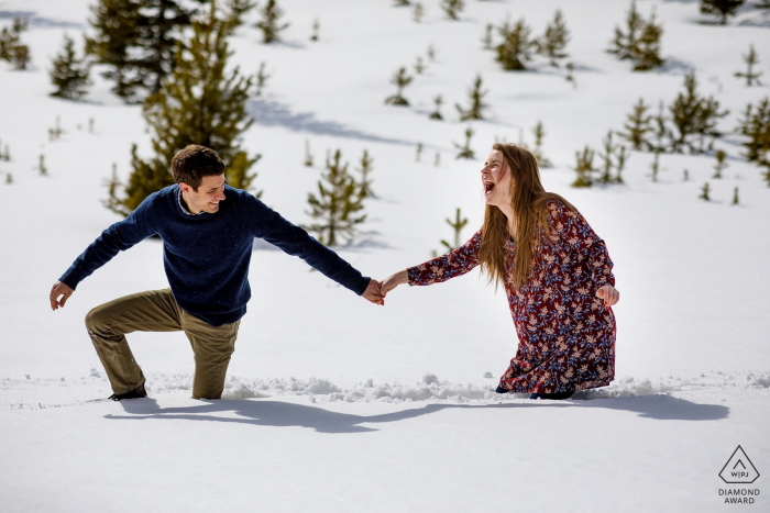 Sapphire Point Engagement Portrait -  Reactions after falling in the snow during their engagement session in Dillon 