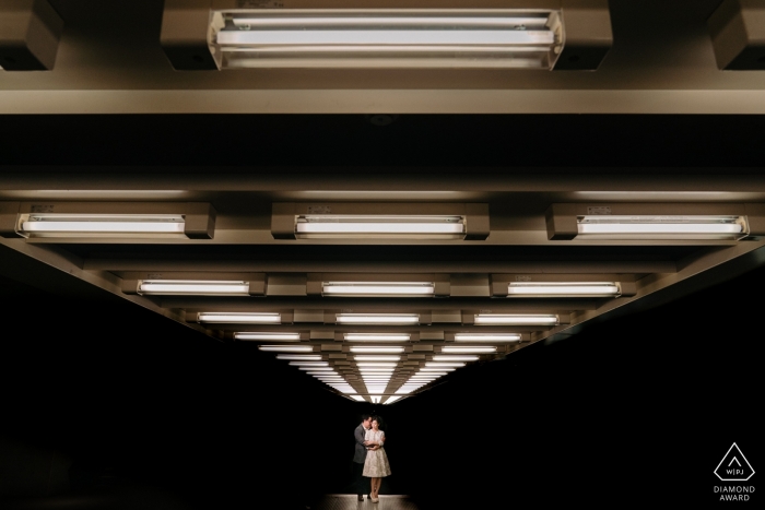 Engagement photo of a couple in the distance lit from above in Antwerp. Engagement photo of a couple in the distance lit from above in Antwerp.