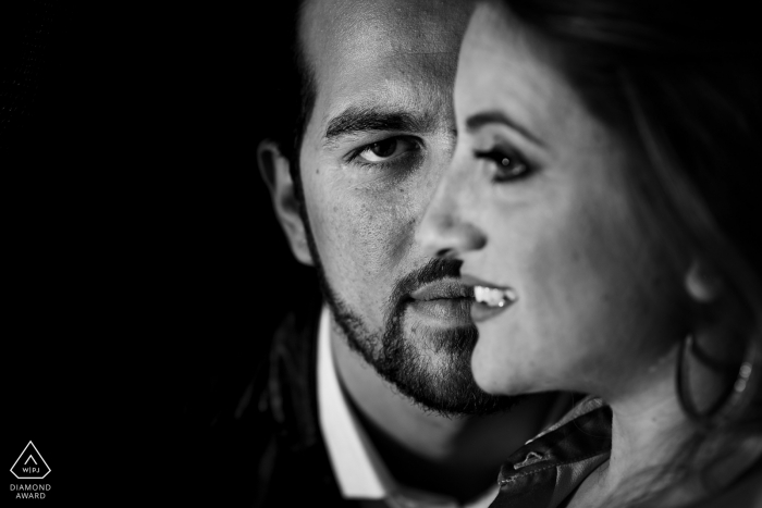 Black and white engagement portrait of a couple with their faces aligned in perfect union in Reggio Calabria. 