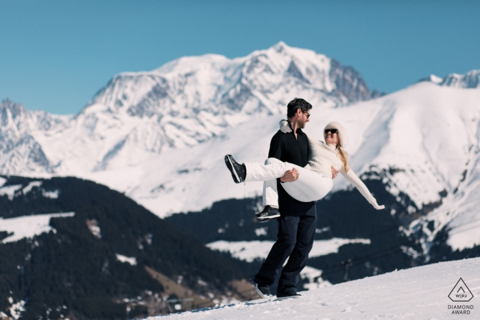 Photo by: <a href="https://www.wpja.com/photos/diamond-award-top-wedding-engagement-photographer/2464571">Sylvain Bouzat - Lyon Megève Engagement Photography showing a couple in the snow with the Mont Blanc