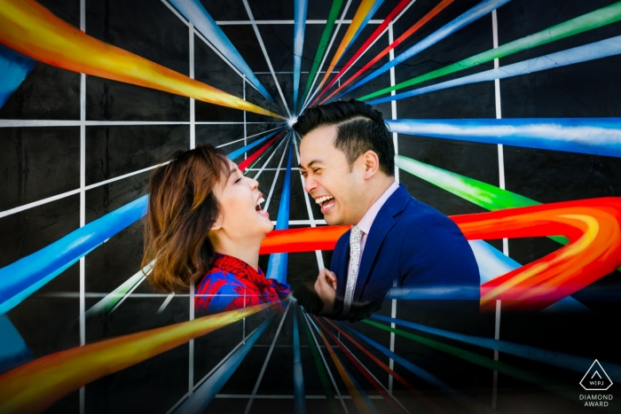 Photo by: <a href="https://www.wpja.com/photos/diamond-award-top-wedding-engagement-photographer/2464901">Tanya Parada - Los Angeles California Engagement portrait of a couple laughing surrounded by vibrant, graphic colors in Venice, California.