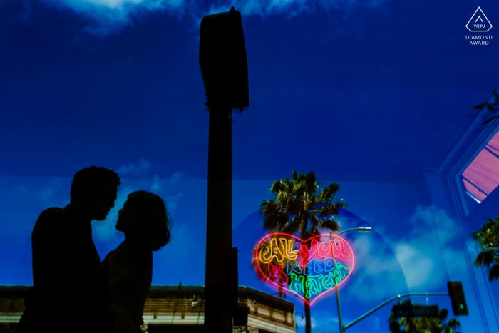Photo by: <a href="https://www.wpja.com/photos/diamond-award-top-wedding-engagement-photographer/2464921">Tanya Parada - Los Angeles California Venice, California Engagement Portrait - I love you Matcha sign reflection with a silhouetted couple
