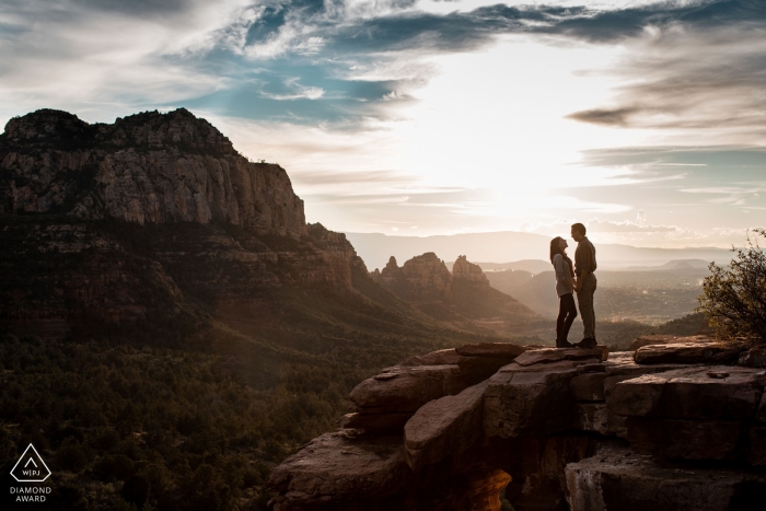 Photo by: <a href="https://www.wpja.com/photos/diamond-award-top-wedding-engagement-photographer/2465226">Courtney Larson - Phoenix Arizona Sedona, AZ Engagement Photography - Couple on mountain top in Sedona