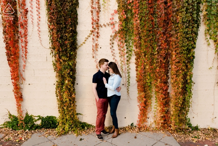 Photo by: <a href="https://www.wpja.com/photos/diamond-award-top-wedding-engagement-photographer/2465771">Laura Robinson - Delano Minnesota St. Anthony Main, MN Engaged Couple in front of colorful autumn ivy wall in Minneapolis