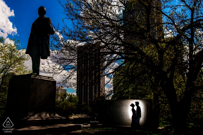 Photo by: <a href="https://www.wpja.com/photos/diamond-award-top-wedding-engagement-photographer/2473046">Victoria Sprung - Chicago Illinois In Lincoln Park, Chicago, a couples silhouette is captured against a monument in this engagement photo shoot