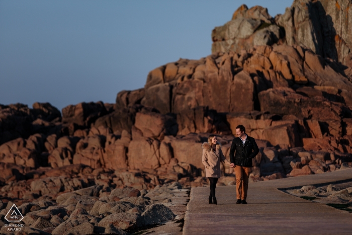 Photo by: <a href="https://www.wpja.com/photos/diamond-award-top-wedding-engagement-photographer/2474201">Catherine Hill - Canterbury Kent Engagement Portrait Session at Corbiere Lighthouse, St Brelades, Jersey, CI - Coastal engagement shoot of a couple walking together