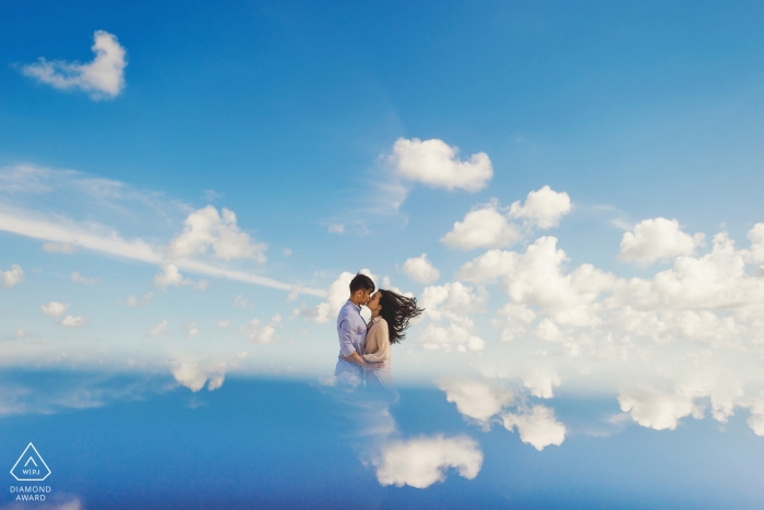 Fuijan- the couple appear to be kissing in the clouds in this pre-wedding portrait session