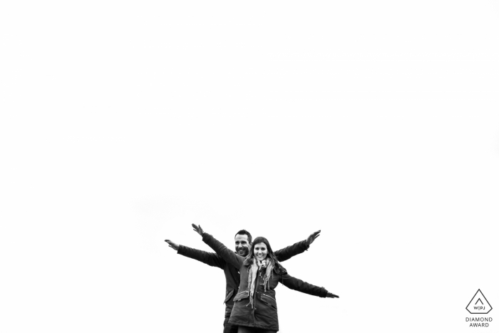 Photo by: <a href="https://www.wpja.com/photos/diamond-award-top-wedding-engagement-photographer/2475696">Miguel Onieva - Madrid Madrid Engagement portrait of a couple with flying open arms and white negative space at Toledo, Castilla-La Mancha (Spain)