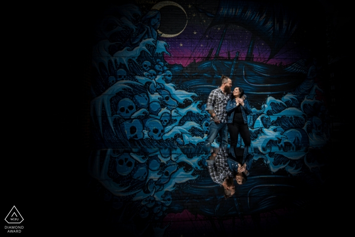 Photo by: <a href="https://www.wpja.com/photos/diamond-award-top-wedding-engagement-photographer/2476311">Penny McCoy - Columbia Heights Minnesota Minneapolis, Minnesota Couple Engagement Portrait in front of painted mural