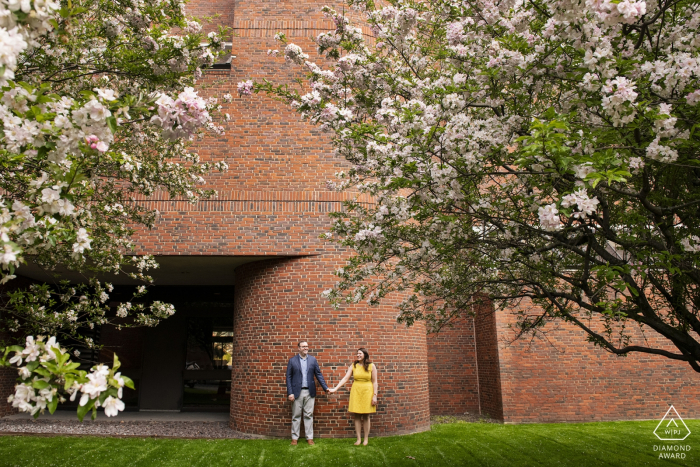 Photo by: <a href="https://www.wpja.com/photos/diamond-award-top-wedding-engagement-photographer/2480216">Simi Rabinowitz - Somerville Massachusetts Cambridge, Massachusetts Engagement Couple Shoot - Wide shot with cherry blossoms and brick wall