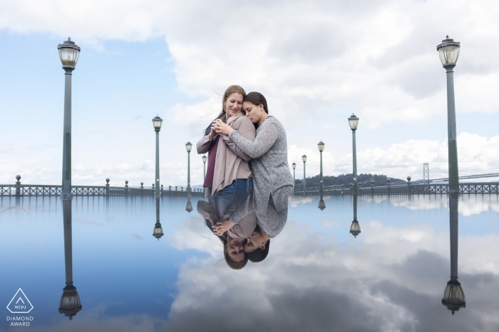 Photo by: <a href="https://www.wpja.com/photos/diamond-award-top-wedding-engagement-photographer/2483646">Ian Chin - San Francisco California Pier 7 reflection during engagement portrait session