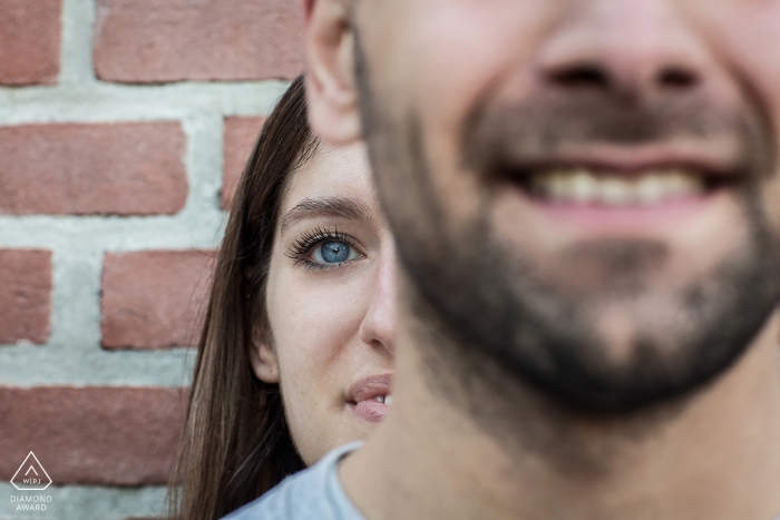 Photo by: <a href="https://www.wpja.com/photos/diamond-award-top-wedding-engagement-photographer/2484966">Michela Bocciarelli - Milano Milano A woman peeks out from behind her fiance in this pre-wedding portrait in Milan, Italy. Taken by a Lombardy photographer.