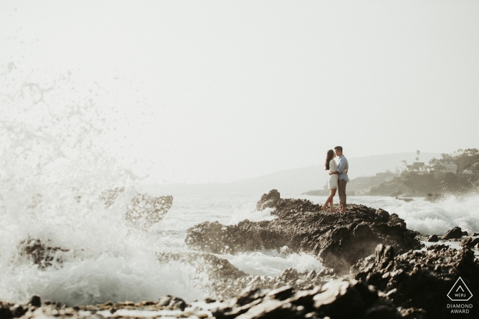 Photo by: <a href="https://www.wpja.com/photos/diamond-award-top-wedding-engagement-photographer/2485581">Raymond Nguyen - Sacramento California A couple kisses as they stand on rocks with waves crashing nearby in San Francisco during their pre-wedding session by a Sacramento, CA photographer