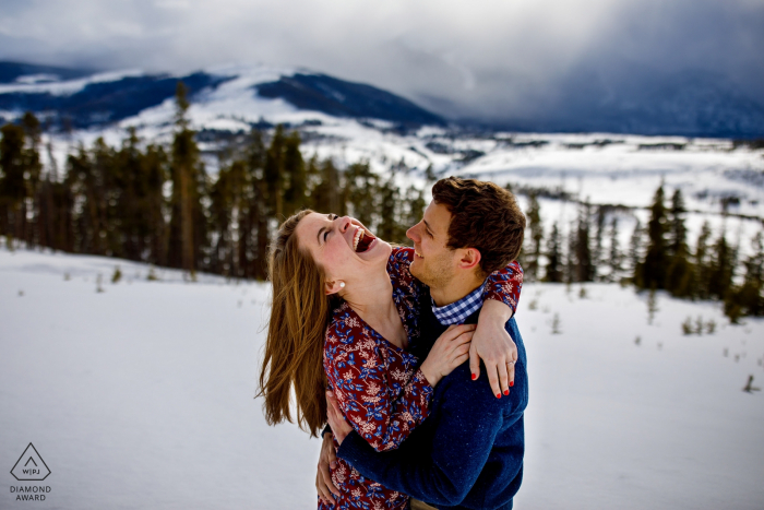 Sharing a laugh during their engagement portrait session in Dillon at Sapphire Point