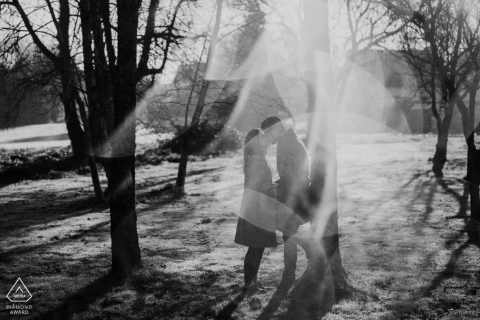 Photo by: <a href="https://www.wpja.com/photos/diamond-award-top-wedding-engagement-photographer/2487181">Christophe Pasteur - Lorient A couple in Lorient, France kisses as light refracts off the morning dew in this black and white pre-wedding photo by a Morbihan, Brittany photographer.