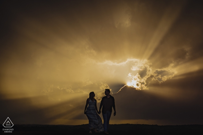 Photo by: <a href="https://www.wpja.com/photos/diamond-award-top-wedding-engagement-photographer/2488256">Orlando Suarez - Kennesaw Georgia Arabia Mountain, Georgia | Sun rays break through the clouds for this creative engagement portrait