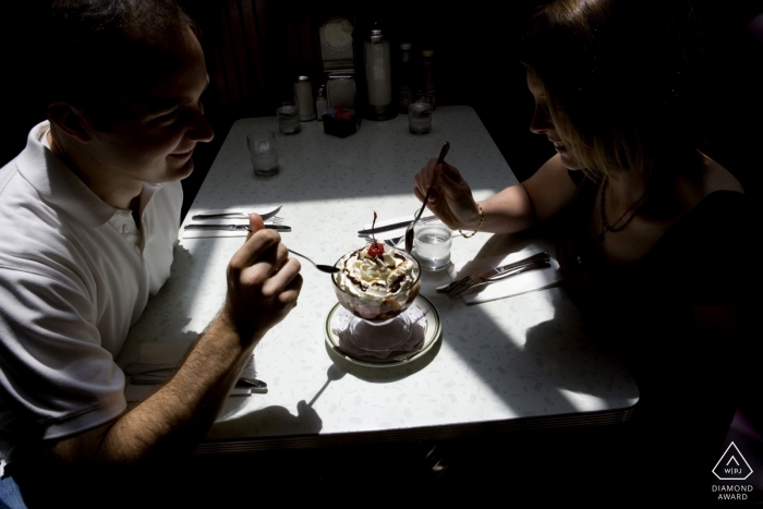 Photo by: <a href="https://www.wpja.com/photos/diamond-award-top-wedding-engagement-photographer/2493281">Joyce Perlman - San Francisco California Engaged couple sharing an ice cream sundae at the Peninsula Creamery in Palo Alto, CA