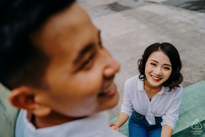 This couple smiles outside during their pre-wedding session in Ho Chi Minh City, Vietnam