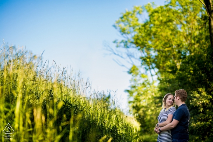 Photo by: <a href="https://www.wpja.com/photos/diamond-award-top-wedding-engagement-photographer/2497441">Matouš Bárta - Prague A man holds his fiance as they stand in a field in Brno in this pre-wedding photo session by a Prague photographer.