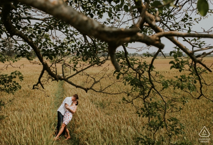 Photo by: <a href="https://www.wpja.com/photos/diamond-award-top-wedding-engagement-photographer/2497671">Trung Dinh - Da Nang Da Nang This Engaged couple kiss in a field during their Pre-wedding shoot in Hoi An Vietnam