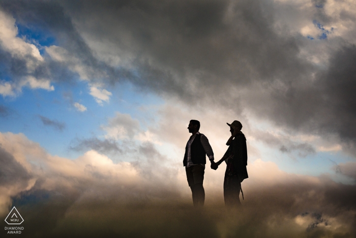 Photo by: <a href="https://www.wpja.com/photos/diamond-award-top-wedding-engagement-photographer/2497736">Emre Nesli - İstanbul Istanbul A couple holds hands and walks together in Mersin through clouds reflected around them in this pre-wedding photo by an Istanbul, Turkey photographer.