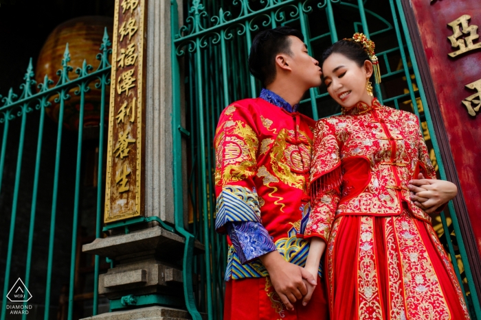 Photo by: <a href="https://www.wpja.com/photos/diamond-award-top-wedding-engagement-photographer/2498246">Jacob Gordon - Ho Chi Minh Ho Chi Minh City - This engagement portrait of a couple holding hands outside of a gate was captured by an engagement photographer