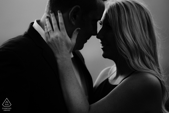 Santa Barbara, California - This black and white engagement photo of an embracing couple showcases the future brides engagement ring 