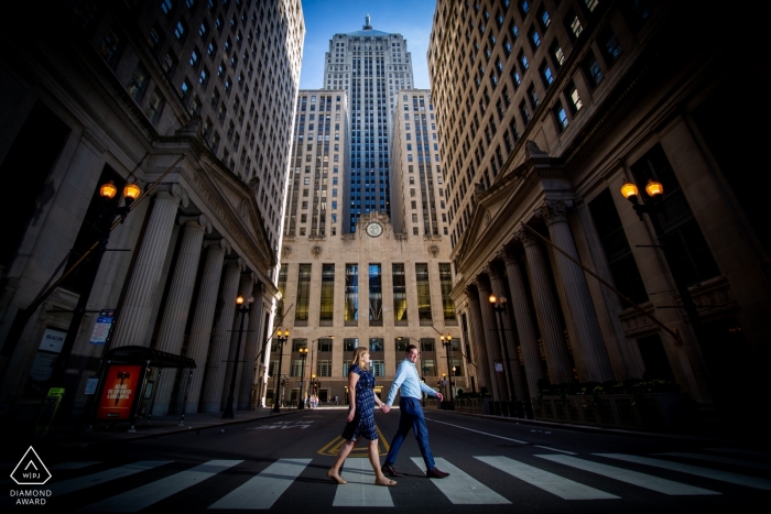 Photo by: <a href="https://www.wpja.com/photos/diamond-award-top-wedding-engagement-photographer/2500996">Victoria Sprung - Chicago Illinois board of trade, chicago engagement shoot with a couple walking down the street