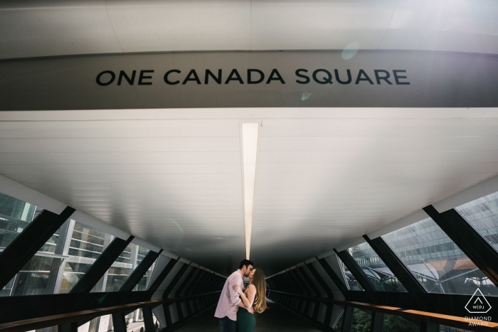 Photo by: <a href="https://www.wpja.com/photos/diamond-award-top-wedding-engagement-photographer/2532591">Kari Bellamy - London Canary Wharf Engagement Shoot Session - Couple kissing in One Canada Water, London England