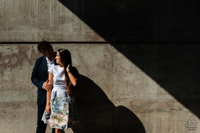 Photo by: <a href="https://www.wpja.com/photos/diamond-award-top-wedding-engagement-photographer/2534641">Esther Gibbons - Montreal Quebec Old Montreal Pre Wedding Portait - Geometric engagement photo of couple in stark sunshine and shadow