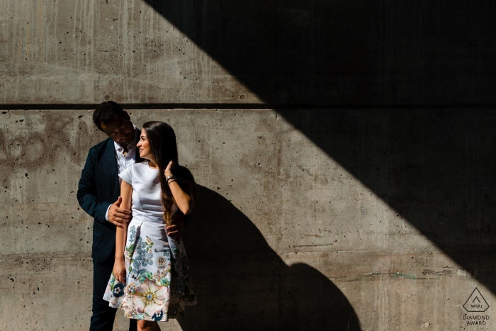 Old Montreal Pre Wedding Portait - Geometric engagement photo of couple in stark sunshine and shadow 