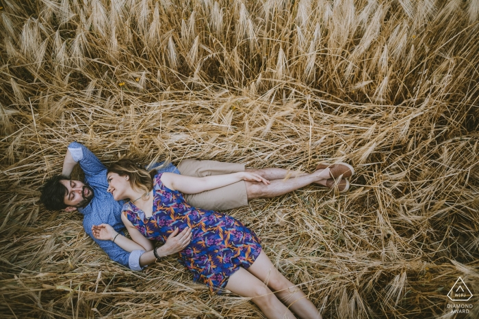 Photo by: <a href="https://www.wpja.com/photos/diamond-award-top-wedding-engagement-photographer/2536556">Emre Nesli - İstanbul Istanbul Cappadocia Turkey Engagement Shoot of a couple lying on a long grass field