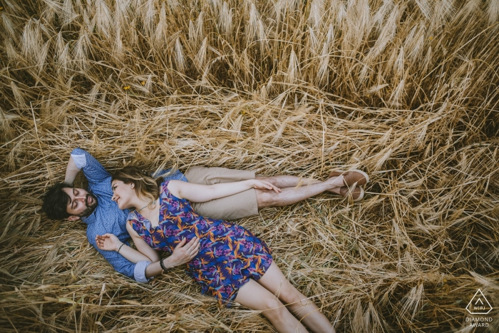 Cappadocia Turkey Engagement Shoot of a couple lying on a long grass field 