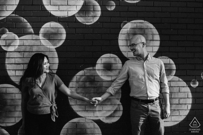 Photo by: <a href="https://www.wpja.com/photos/diamond-award-top-wedding-engagement-photographer/2538171">Natasha Lamalle - Washington DC District Of Columbia Eastern Market in DC Weddings - Engaged couple are playing with a mural in Eastern Market.