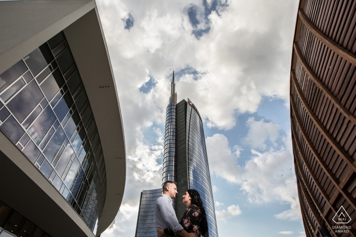 Italian engagement photography in the city with tall buildings.