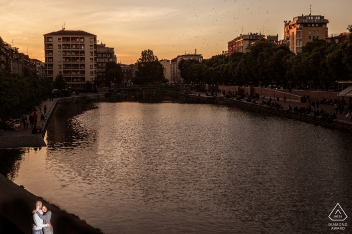 Photo by: <a href="https://www.wpja.com/photos/diamond-award-top-wedding-engagement-photographer/2545332">Michela Bocciarelli - Milano Milano Milano, Italy engagement photo at sunset at the water with a solo light