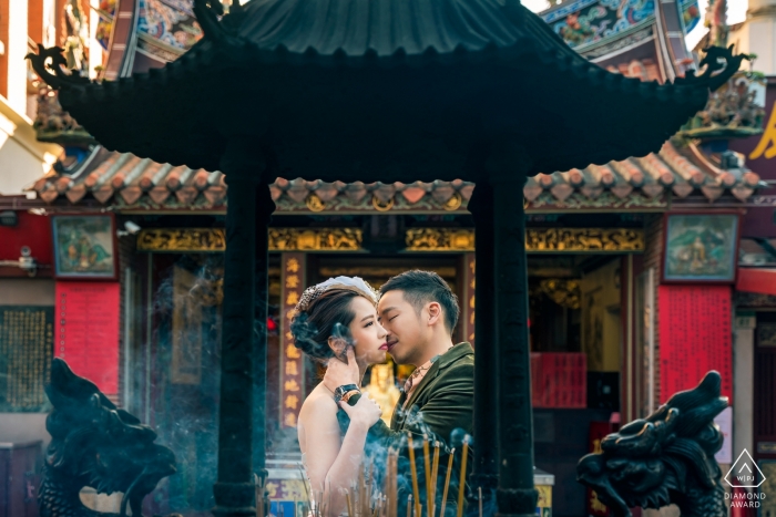 Photo by: <a href="https://www.wpja.com/photos/diamond-award-top-wedding-engagement-photographer/2545752">Will Tee - Taipei City Xiahai Chenghuang Temple Photography - The engaged couple were kissing in front of the incense burner of the temple.
