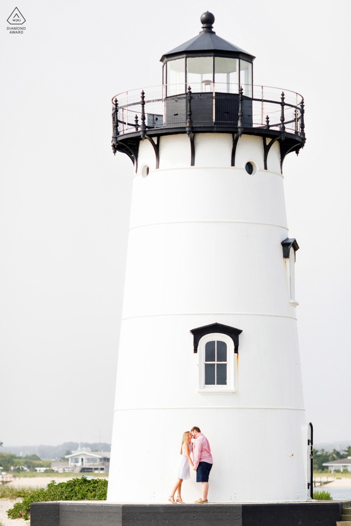 Photo by: <a href="https://www.wpja.com/photos/diamond-award-top-wedding-engagement-photographer/2545885">Alex Paul - Boston Massachusetts Engagement portrait of a couple at a New England lighthouse in MA