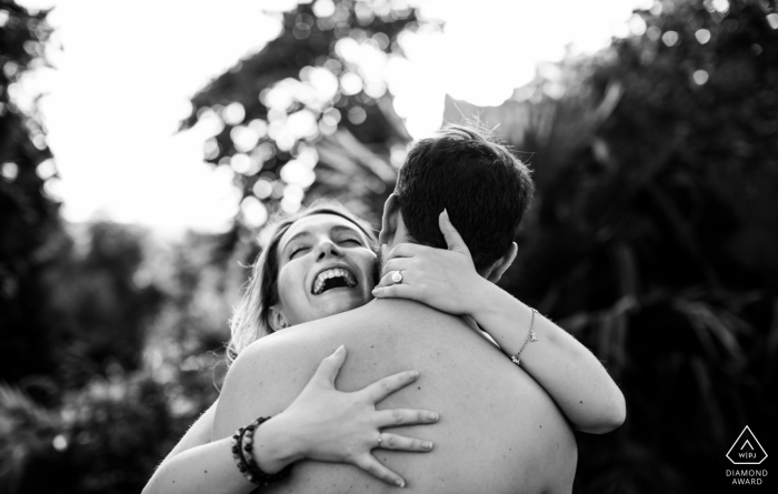 Photo by: <a href="https://www.wpja.com/photos/diamond-award-top-wedding-engagement-photographer/2547039">Isabelle Bazin - Goutz Casterat-Lectourois, Gers | A girl laughing in the arm of her boyfriend during pre-wedding engagement photoshoot