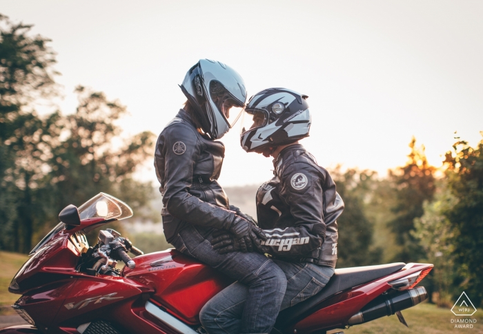 Photo by: <a href="https://www.wpja.com/photos/diamond-award-top-wedding-engagement-photographer/2547040">Isabelle Bazin - Goutz Gers, South of France motorcyclist couple sitting on bike with helmets during engagement portrait session