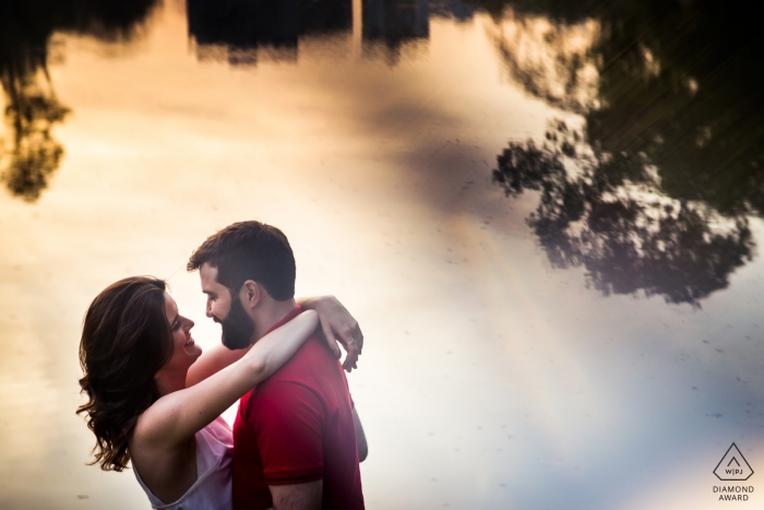 Photographie de fiançailles pour Vicosa, Brésil - Un couple s'embrassant près d'un lac