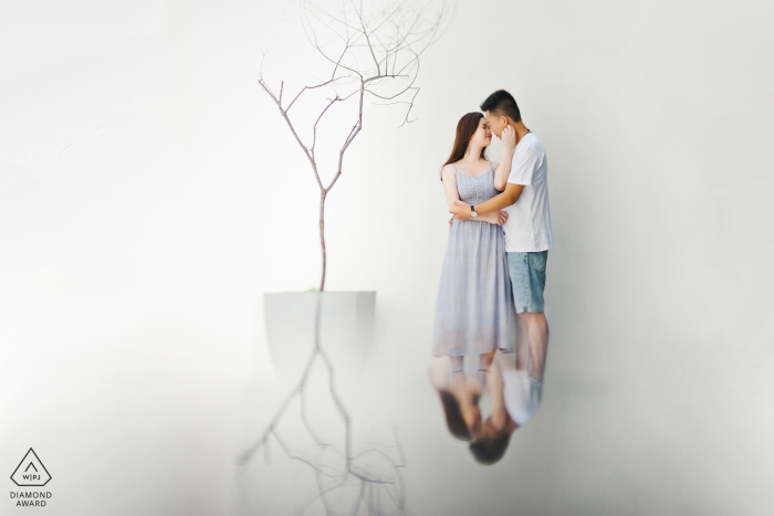 Photo by: <a href="https://www.wpja.com/photos/diamond-award-top-wedding-engagement-photographer/2547230">Qi Xiang - Nanping Engagement Photos from Nanping Fujian - Portrait contains: couple, embrace, hotel, tree, reflection, white
